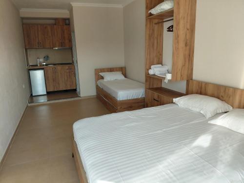 a small room with two beds and a kitchen at Hotel Lalez Durres in Durrës