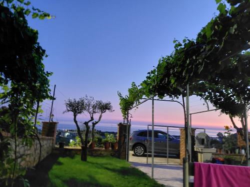 a car parked in a driveway with a view of the ocean at Hotel Lalez Durres in Durrës