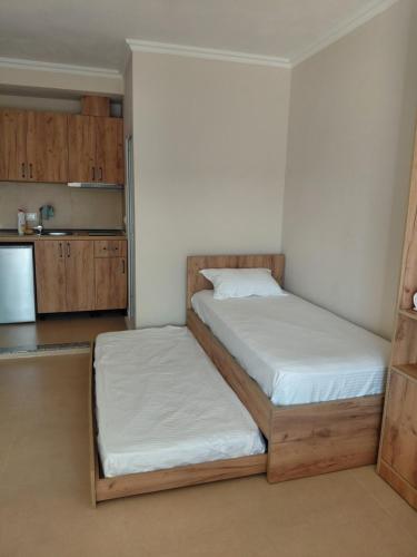 a small kitchen with two beds in a room at Hotel Lalez Durres in Durrës