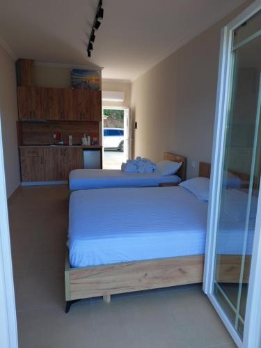 a bedroom with two beds and a window at Hotel Lalez Durres in Durrës