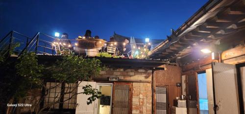 a balcony with lights on top of a building at Eosahwa in Jeonju