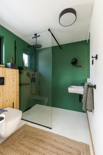 a bathroom with a glass shower and a toilet at Danube Cottage in Komárno