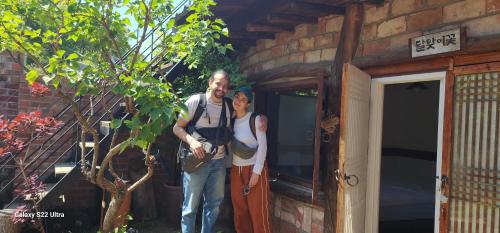 a man and a woman standing outside of a building at Eosahwa in Jeonju