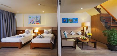 a hotel room with two beds and a staircase at The Cliff Resort & Residences in Mui Ne