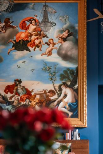 a painting of angels on a wall in a room at La Reserve 1785 Canggu Beach - Adults Only in Canggu