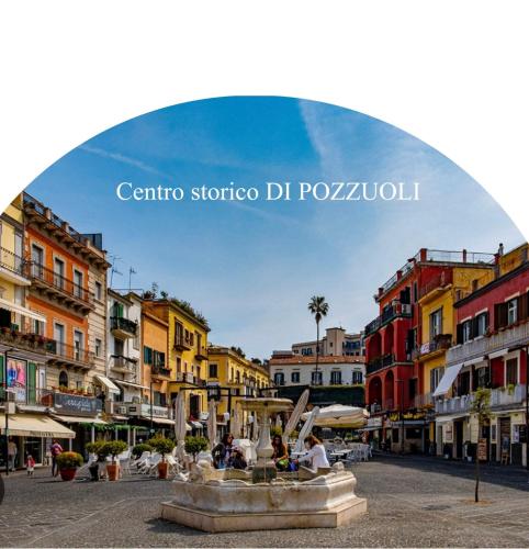 a view of a city with a fountain in a street at Lindas Room in Pozzuoli