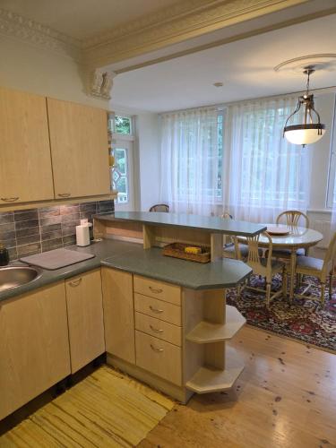 a kitchen with a table and a dining room at Baltic beach villa 2 in Jūrmala