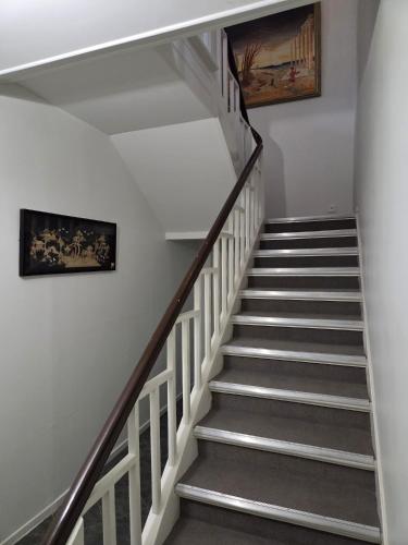 a staircase in a house with a painting on the wall at Baltic beach villa 2 in Jūrmala
