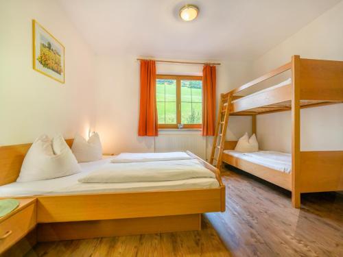 a bedroom with two bunk beds and a window at Apartment in Neustift in a quiet location in Neustift im Stubaital