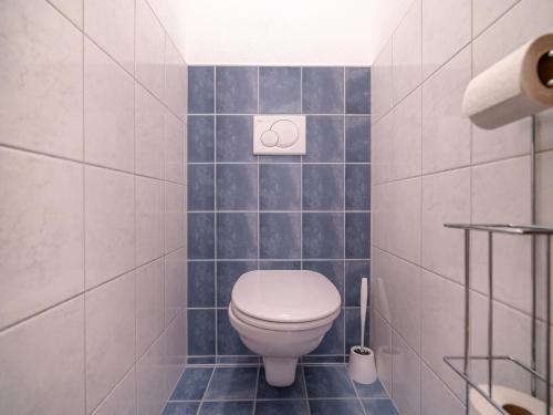 a bathroom with a toilet in a tiled room at Apartment in Neustift in a quiet location in Neustift im Stubaital