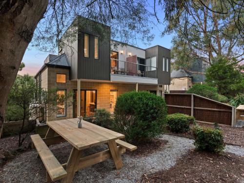 a house with a picnic table in front of it at The Sebel Creswick Forest Resort in Creswick