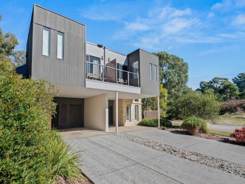 a large house with a balcony on a driveway at The Sebel Creswick Forest Resort in Creswick