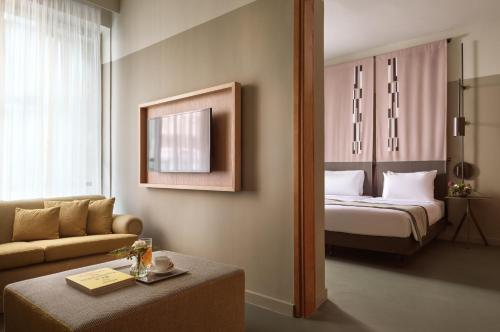 a hotel room with a bed and a couch at City Hotel Thessaloniki in Thessaloniki