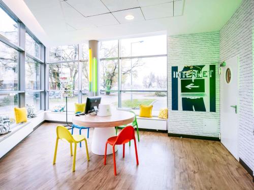 an office with a table with chairs and a computer at ibis budget Warszawa Centrum in Warsaw