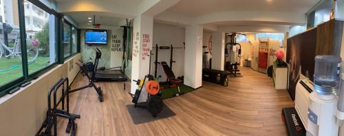 a gym with treadmills and exercise bikes in a room at Hotel Majorca sul Mare in centro a Riccione con Area Fitness in Riccione