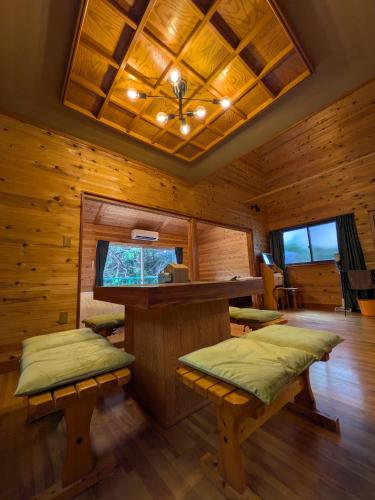 a log cabin with a bar and benches in it at Morifuneya Ine - 森舟屋 伊根 - in Kameshima