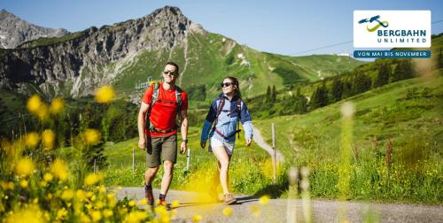 a man and a woman walking down a road at Bierhotel in Oberstdorf