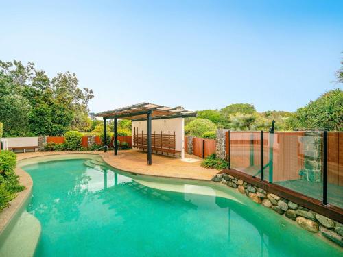 a swimming pool with a gazebo in a yard at The Sebel Twin Waters in Twin Waters