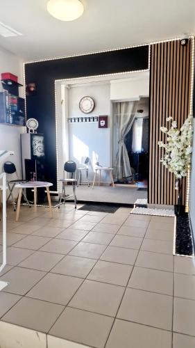 a large living room with chairs and a table at Hotel Jolie in Brazii de Sus