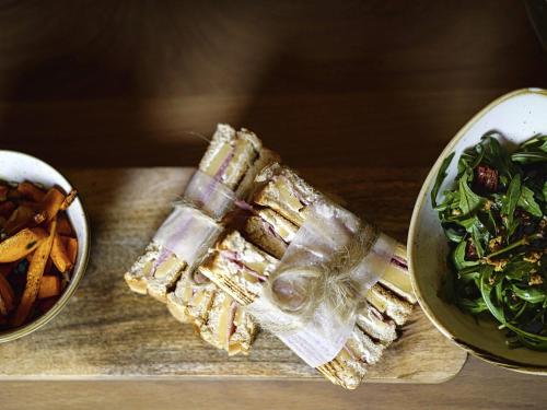 a sandwich and a bowl of food on a cutting board at Mercure Valence in Valence