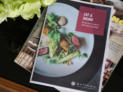 a magazine with a picture of a plate of food at Pullman Sydney Olympic Park in Sydney