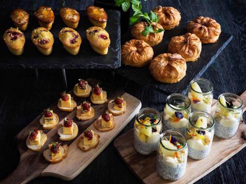 a bunch of pastries and breads on a table at Pullman Sydney Olympic Park in Sydney