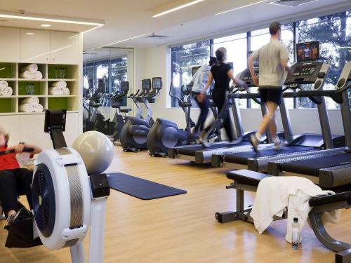 a gym with people running on treadles in a gym at Pullman Sydney Olympic Park in Sydney