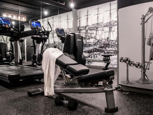 a gym with cardio equipment and a picture of a boat at ibis Sydney Barangaroo in Sydney