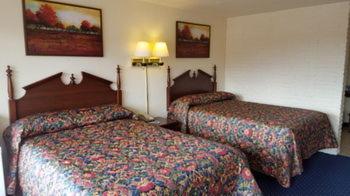 a hotel room with two beds in a room at Red Carpet Inn - Blacksburg in Blacksburg