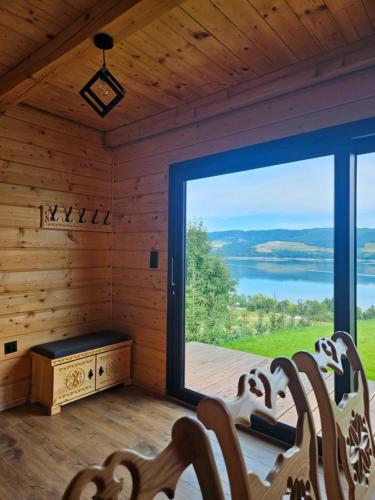 a room with a large window in a log cabin at Velo Active & Spa in Frydman