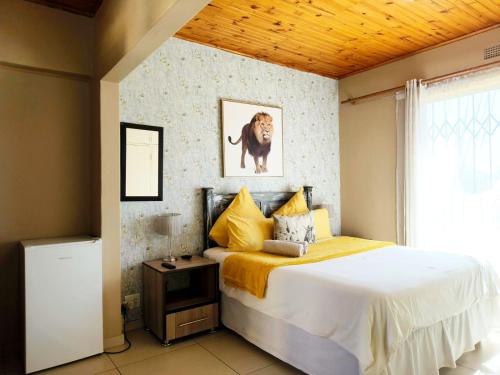 a bedroom with a bed with a dog on the wall at Tokelo Guesthouse Emalahleni in Witbank