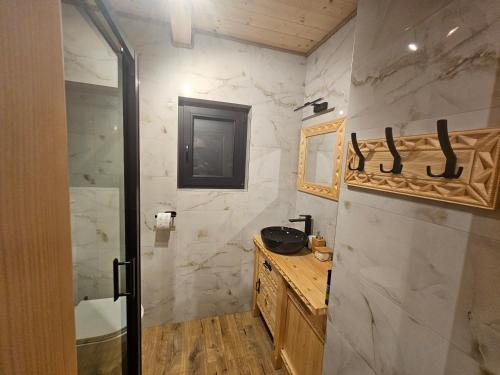 a bathroom with a shower and a sink and a toilet at Velo Active & Spa in Frydman