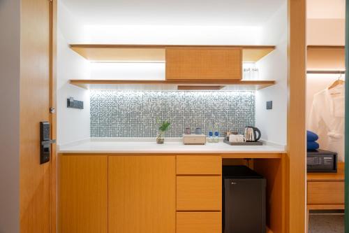 a small kitchen with a counter and a sink at Wyndham Garden Phuket Kamala in Kamala Beach