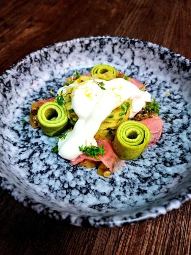 a plate of food on a wooden table at Mintrops Stadt Hotel Margarethenhöhe in Essen