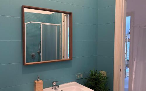 a bathroom with a mirror and a sink at Tucano Mediceo Home in Pisa