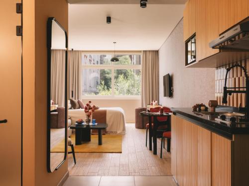 a room with a kitchen and a living room at Saint J Hotel by Brassbell in Cairo