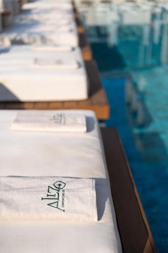 a row of beds in a swimming pool at Alizo Comfort Chic Stay Rhodes - Adults Only in Ixia