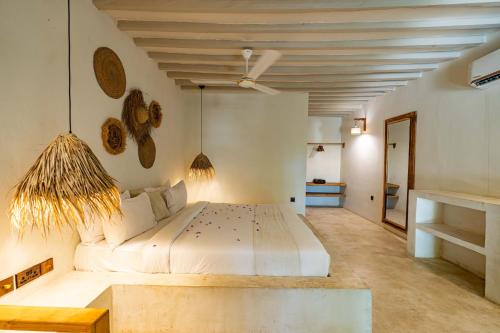 a bedroom with a large bed in a room at Seconda Stella Romantic Hideaway in Jambiani