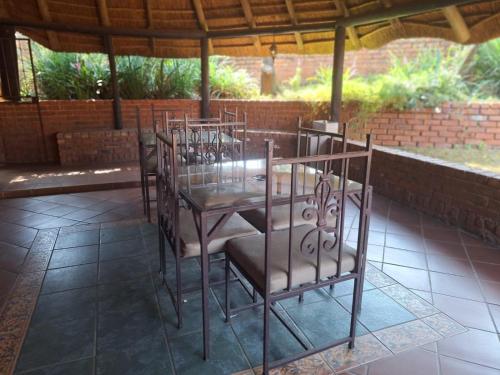 a group of chairs and a table in a patio at Mount Festiva Lodge in Akasia