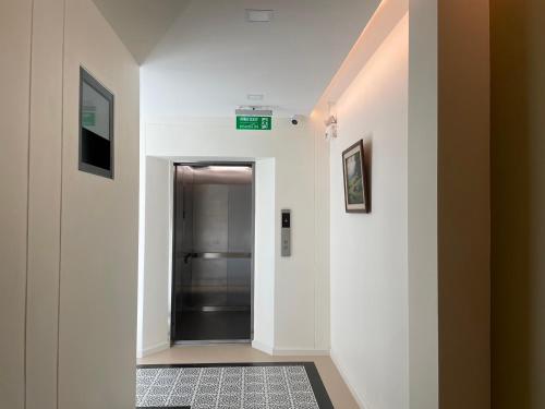 a hallway with a elevator in a building at Airport one station hometel - Suvarnabhumi - SHA Extra Plus in Bangkok