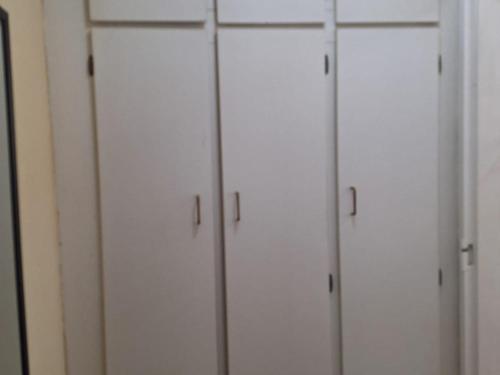 a group of white cabinets in a room at Mount Festiva Lodge in Akasia