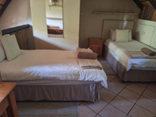 a hotel room with two beds and a window at Mount Festiva Lodge in Akasia