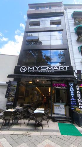 a restaurant with tables and chairs in front of a building at MY Smart in Yalova