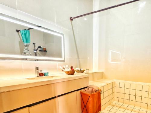 a bathroom with a tub and a sink and a mirror at Luang Prabang chanon hotel in Luang Prabang