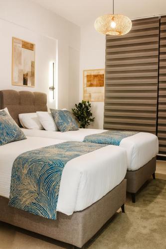 two beds sitting next to each other in a bedroom at Elegant Ephesus Suites - Artemis in Selçuk