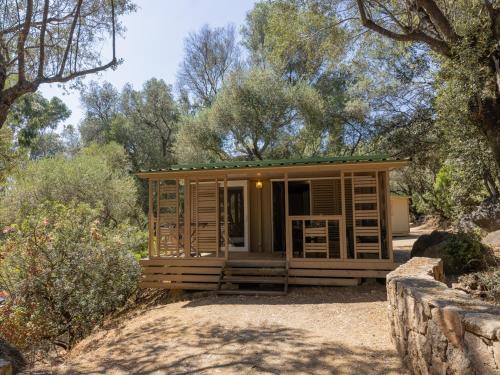 a small cabin in a forest with trees at Vigna Maggiore in Olmeto