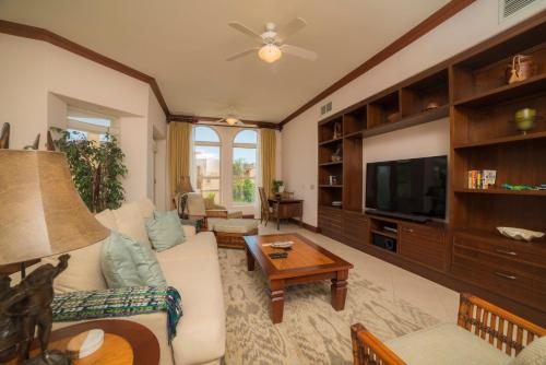 a living room with a couch and a tv at Bella Vista 2D 3 bdrs pool view in Los Suenos in Herradura