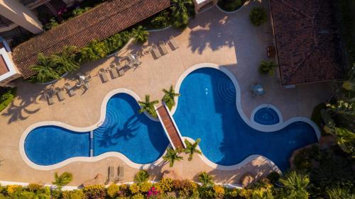 an overhead view of a swimming pool at a resort at Bella Vista 2D 3 bdrs pool view in Los Suenos in Herradura