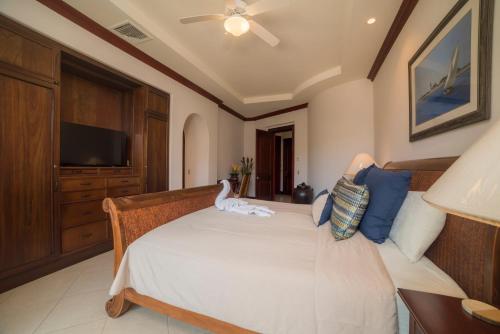 a bedroom with a bed with a dog sitting on it at Bella Vista 2D 3 bdrs pool view in Los Suenos in Herradura
