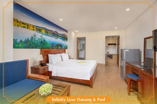 a hotel room with a bed and a kitchen at Infinity Luxe Danang & Pool in Da Nang